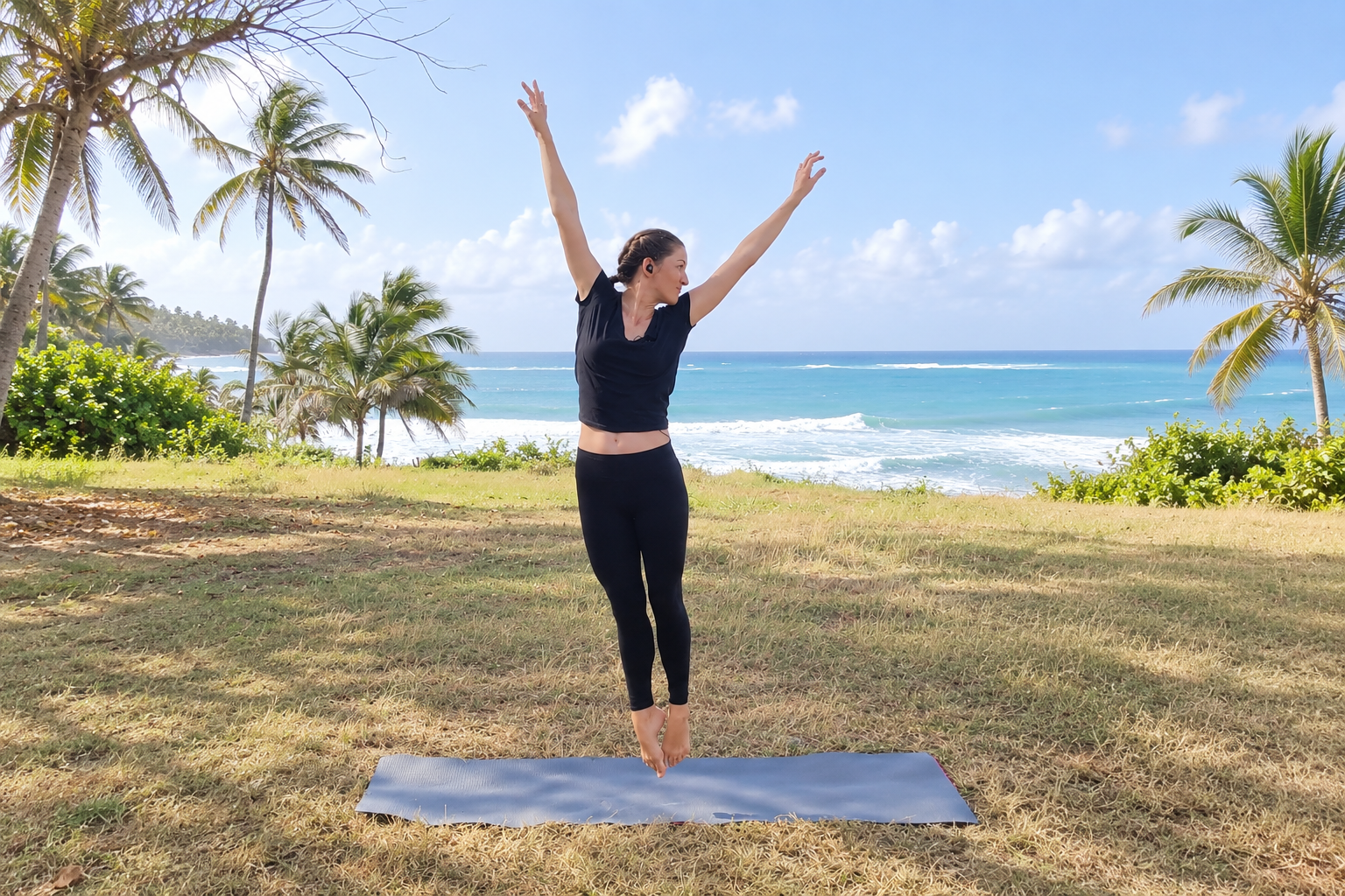 Joanie moving with her arms lifted during an outdoor cardio dance session.